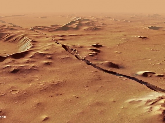 A view of the  Cerberus Fossae system on Mars, showing fractures cut through hills and craters