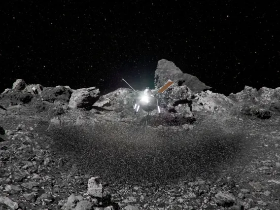 Artist&#039;s impression of the OSIRIS-REx spacecraft kicking up rocks during sample collection on asteroid Bennu&#039;s surface